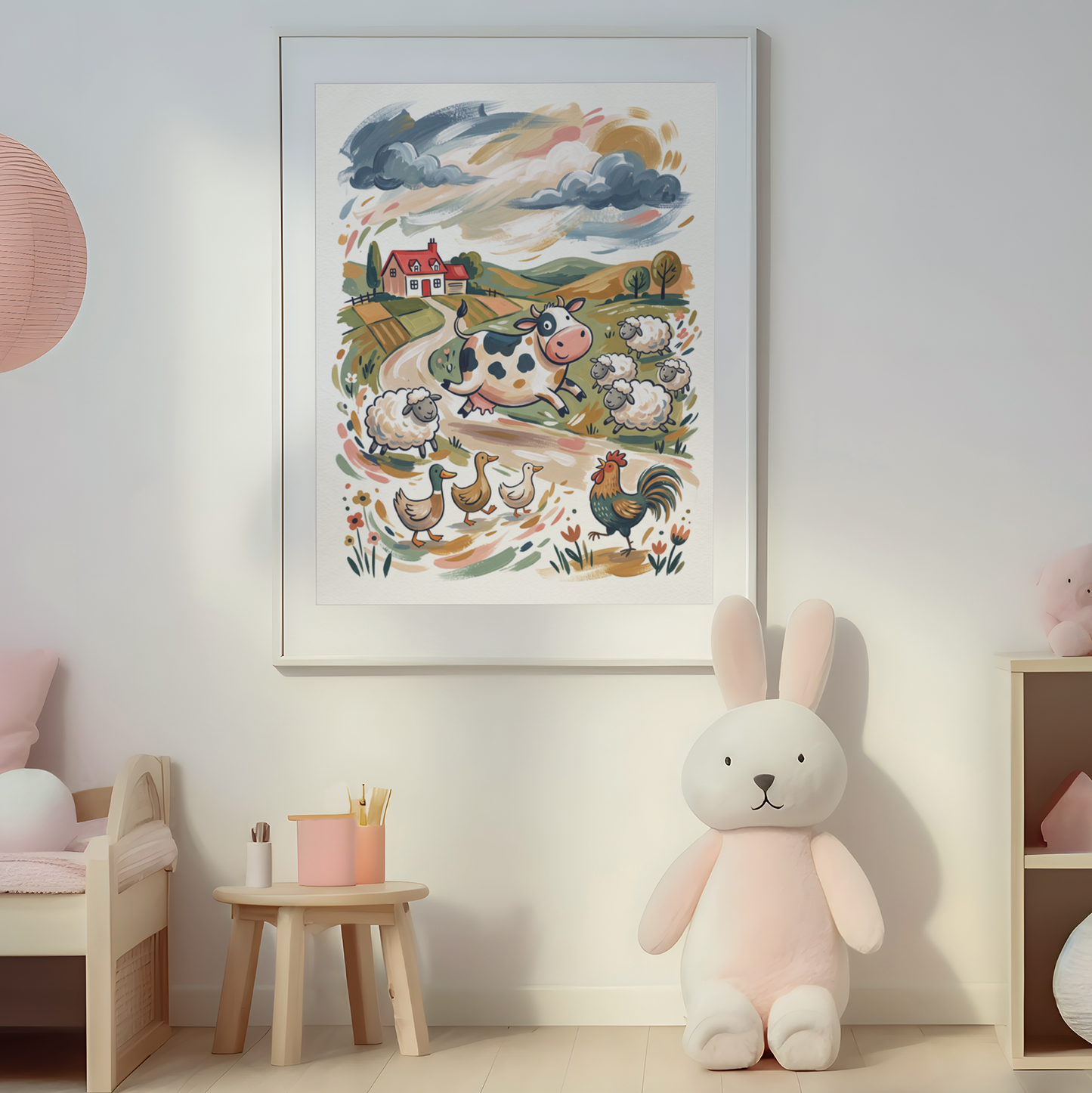 A framed pastel art print depicting a whimsical farm scene with cows, chickens, ducks, and a rooster, displayed on a light gray wall in a styled children's room with a pink bench, hanging lamp, and plush toys.