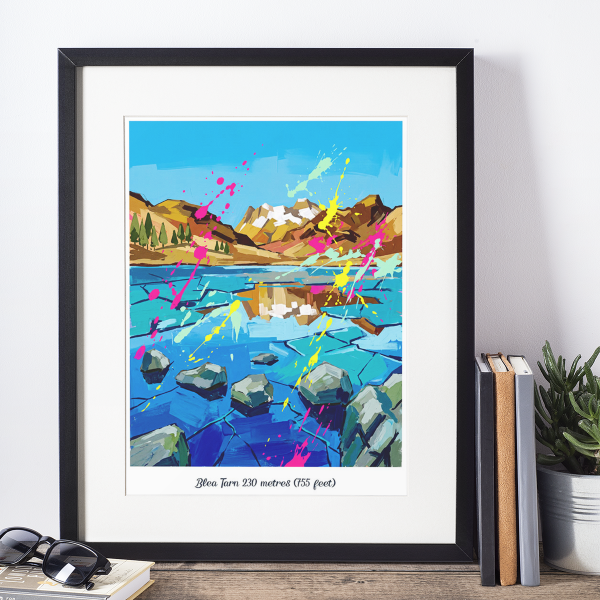 Black framed art print featuring colorful lake, rocks, and splash paint landscape