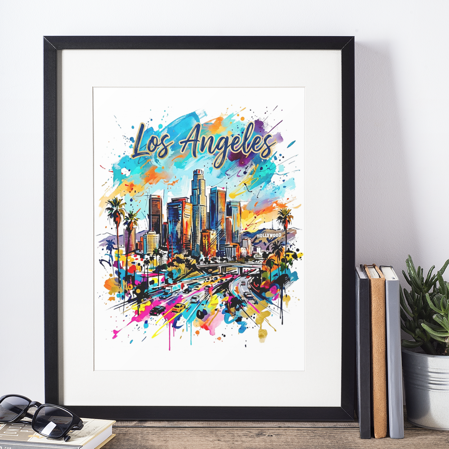 Black-framed Los Angeles skyline art print with palm trees and Hollywood sign, paint splatter