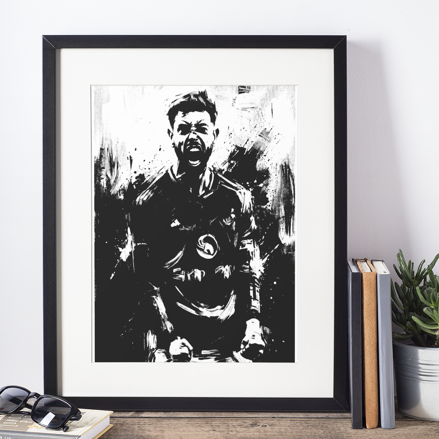 Framed black border black-and-white football player celebration art print, ink splatter portrait