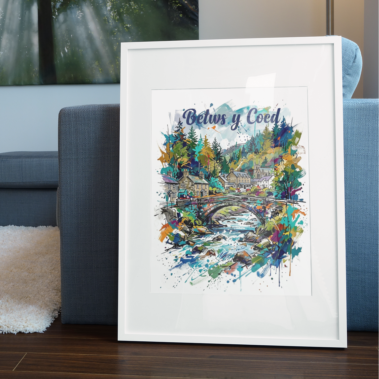 White-framed landscape art print showing colorful bridge, river, and village houses