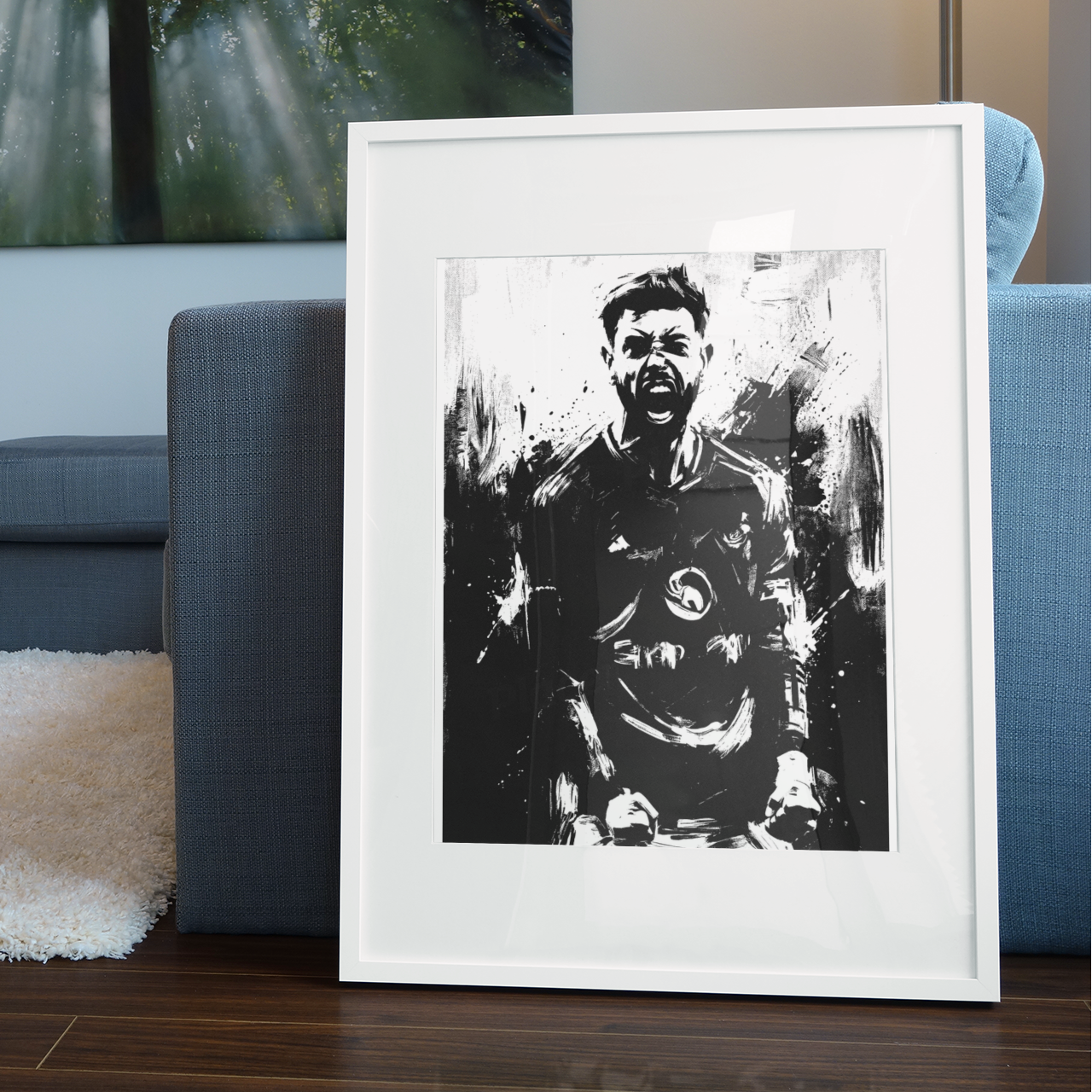 Framed black-and-white football player celebration art print with ink-splatter portrait